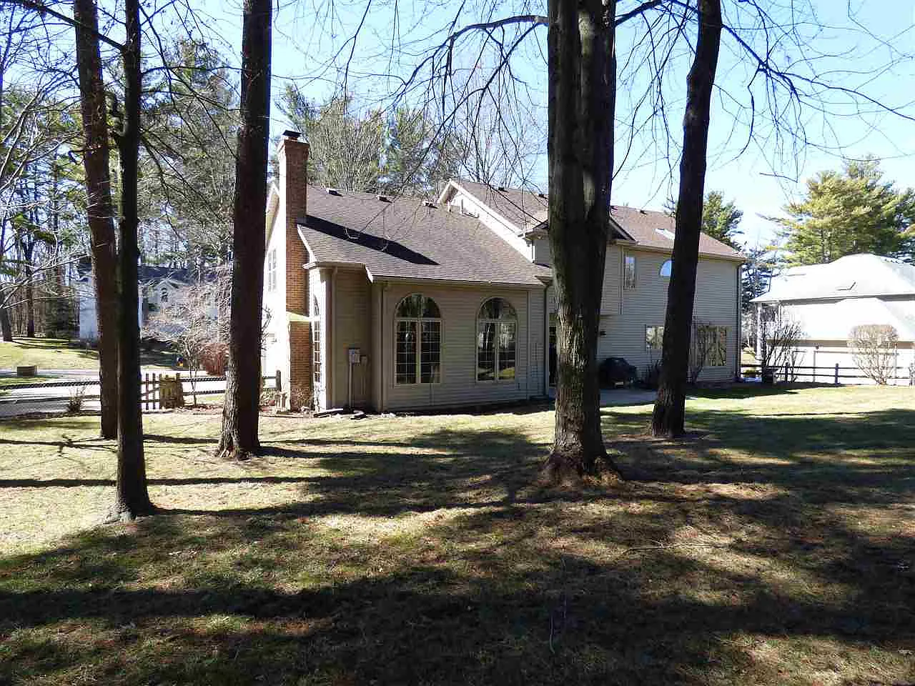 Rear of the home and backyard with mature trees